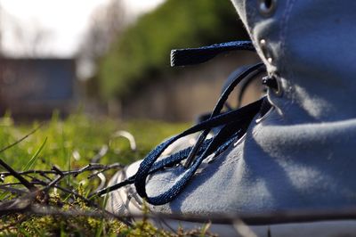 Close-up of shoe on grassy field