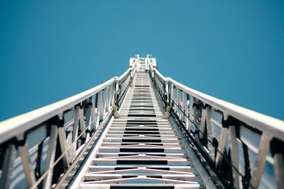 Low angle view of bridge against clear blue sky