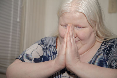 Portrait of woman sitting at home