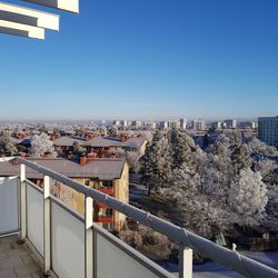 High angle view of cityscape against clear blue sky