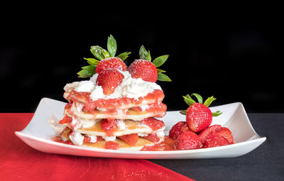 Close-up of strawberriy pancakes in a plate on table