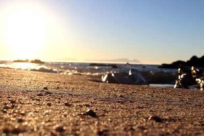 Surface level of beach against clear sky