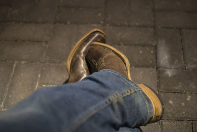 Low section of man standing on sidewalk