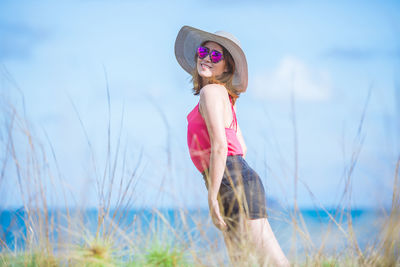 Woman wearing hat while standing on land