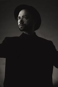 Portrait of young man standing against sky