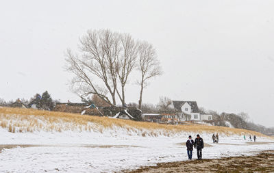 People walking on snow covered land