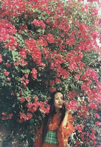 Woman standing by flowering plants