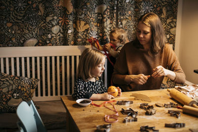 Mother and children making cookies at home