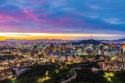 High angle view of illuminated buildings against sky during sunset