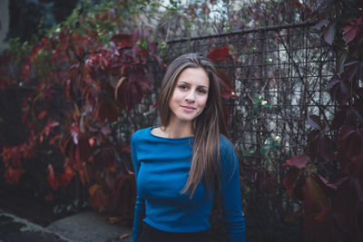 Girl in a blue long sleeve shirt on a street. atumn time.