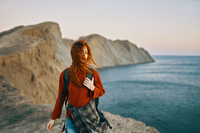 Rear view of woman looking at sea against sky