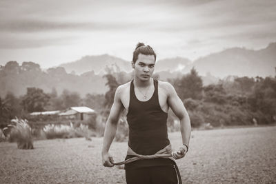 Portrait of man standing on land against sky