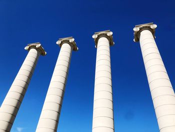 Low angle view of smoke stack against blue sky