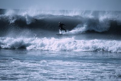 People surfing in sea