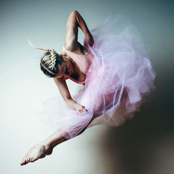 Woman dancing against white background