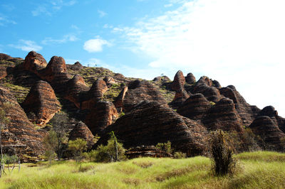 Stack of rocks on landscape against sky