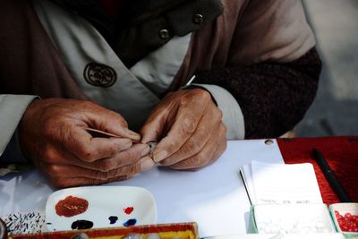 Cropped image of craftsperson working at workshop