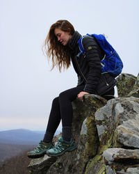 Low angle view of woman standing on rock