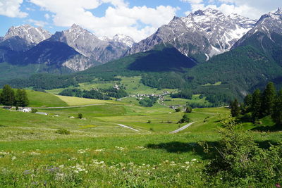 Scenic view of field and mountains against sky