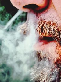 Close-up of woman smoking outdoors