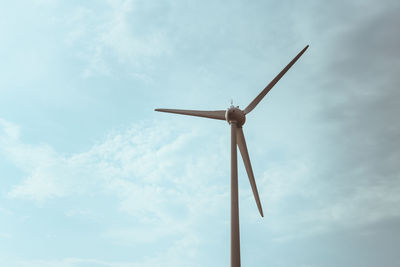 Low angle view of windmill against sky