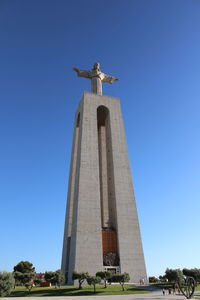 Low angle view of statue against clear blue sky