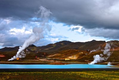 Scenic view of mountains against cloudy sky