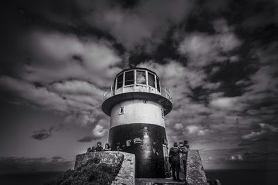 Lighthouse against cloudy sky