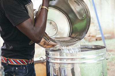 Man pouring water into tank