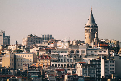 Clock tower in city against sky