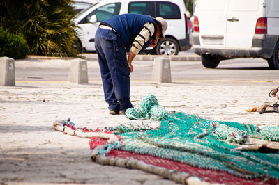 Man working on street in city