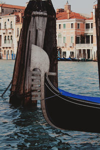 Boats in canal along buildings