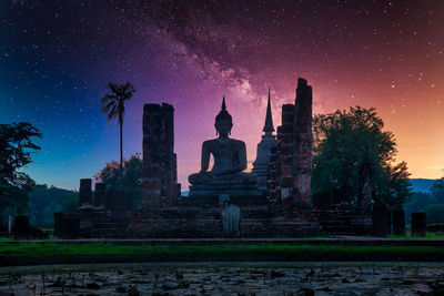 Low angle view of buildings against sky at night