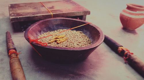 High angle view of grains in container amidst woods