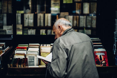 Midsection of man reading book