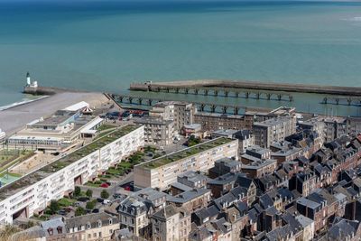 High angle view of buildings by sea against sky