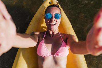 High angle view of woman lying down on canoe