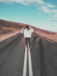 Rear view of man on road against sky