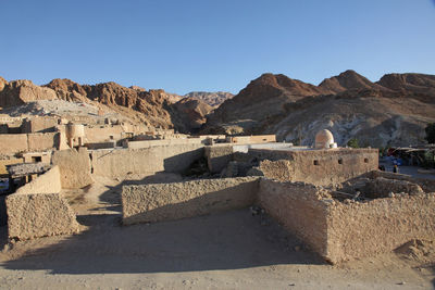 Old ruins and mountains against clear sky at chebika