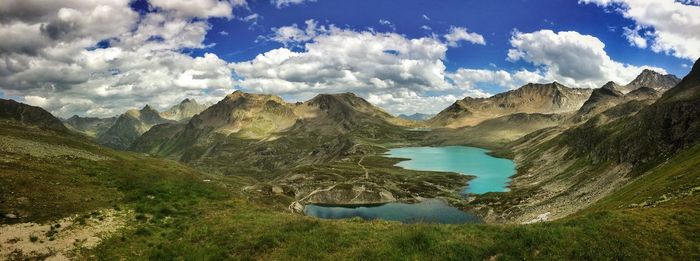 Scenic view of mountains against cloudy sky