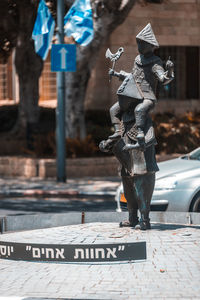 Statue on street in city