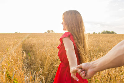 Side view of woman standing in field