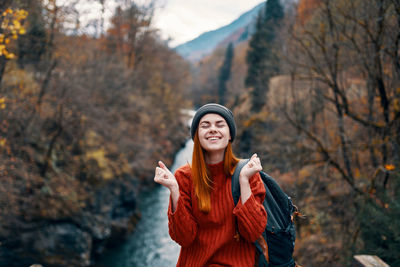 Young woman standing in park during autumn