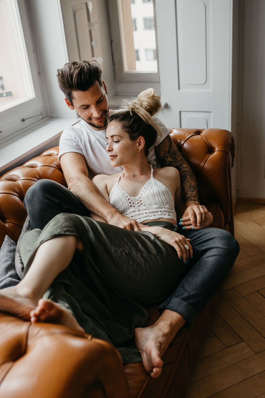 Loving young couple resting at home