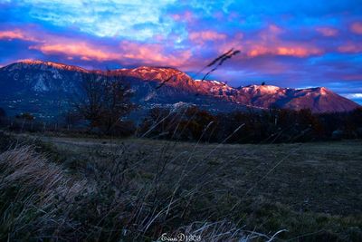 Scenic view of snowcapped mountains against sky during sunset