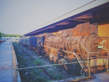 Train on railroad track against clear sky