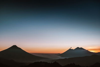 Scenic view of silhouette mountains against sky during sunset