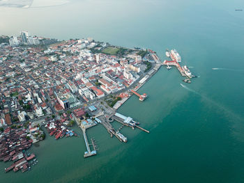 High angle view of sea and buildings in city