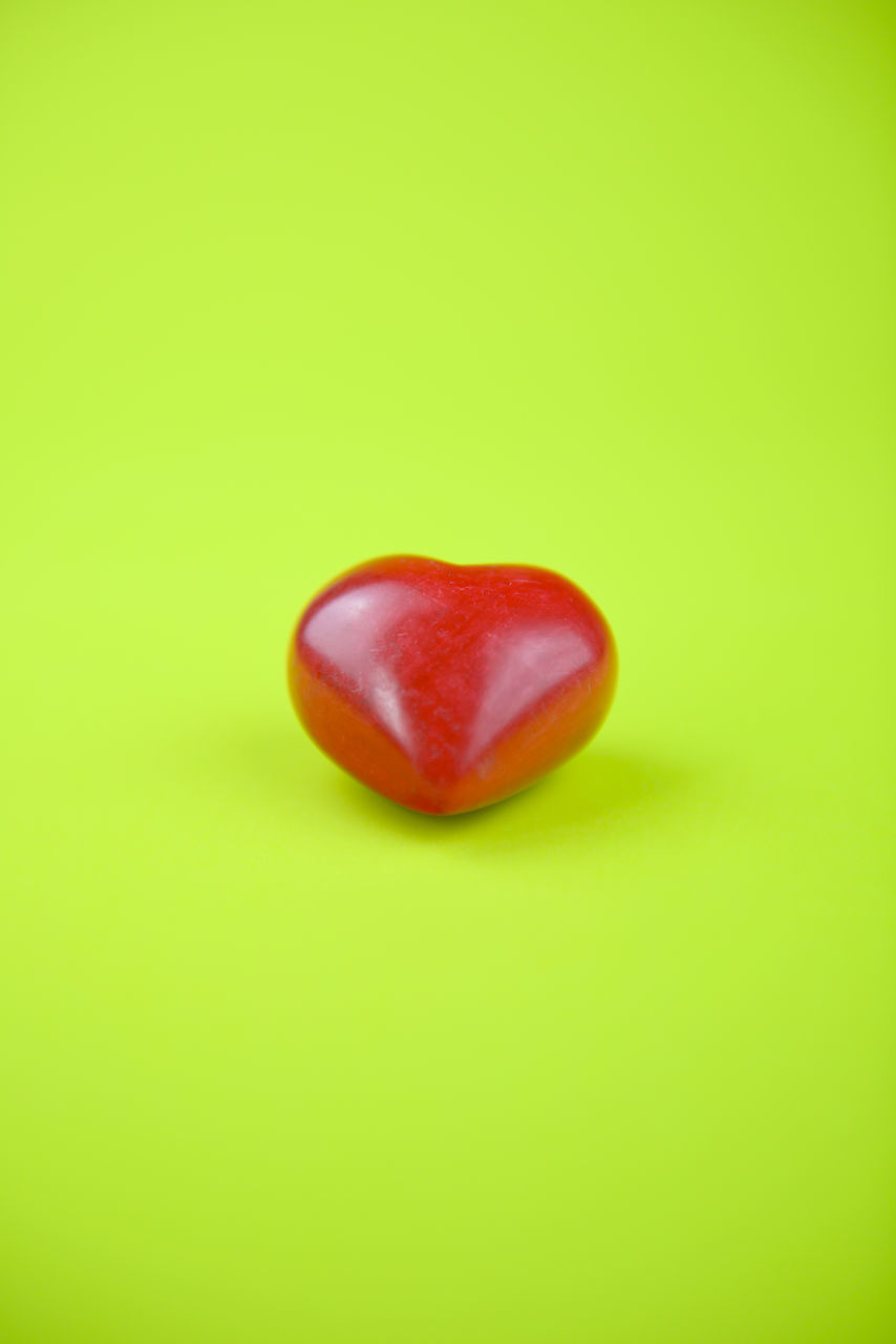 CLOSE-UP OF RED HEART SHAPE OF GREEN LEAF