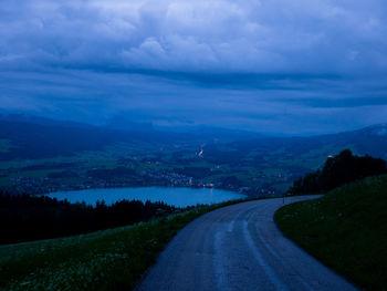 Empty road along landscape and mountains against sky